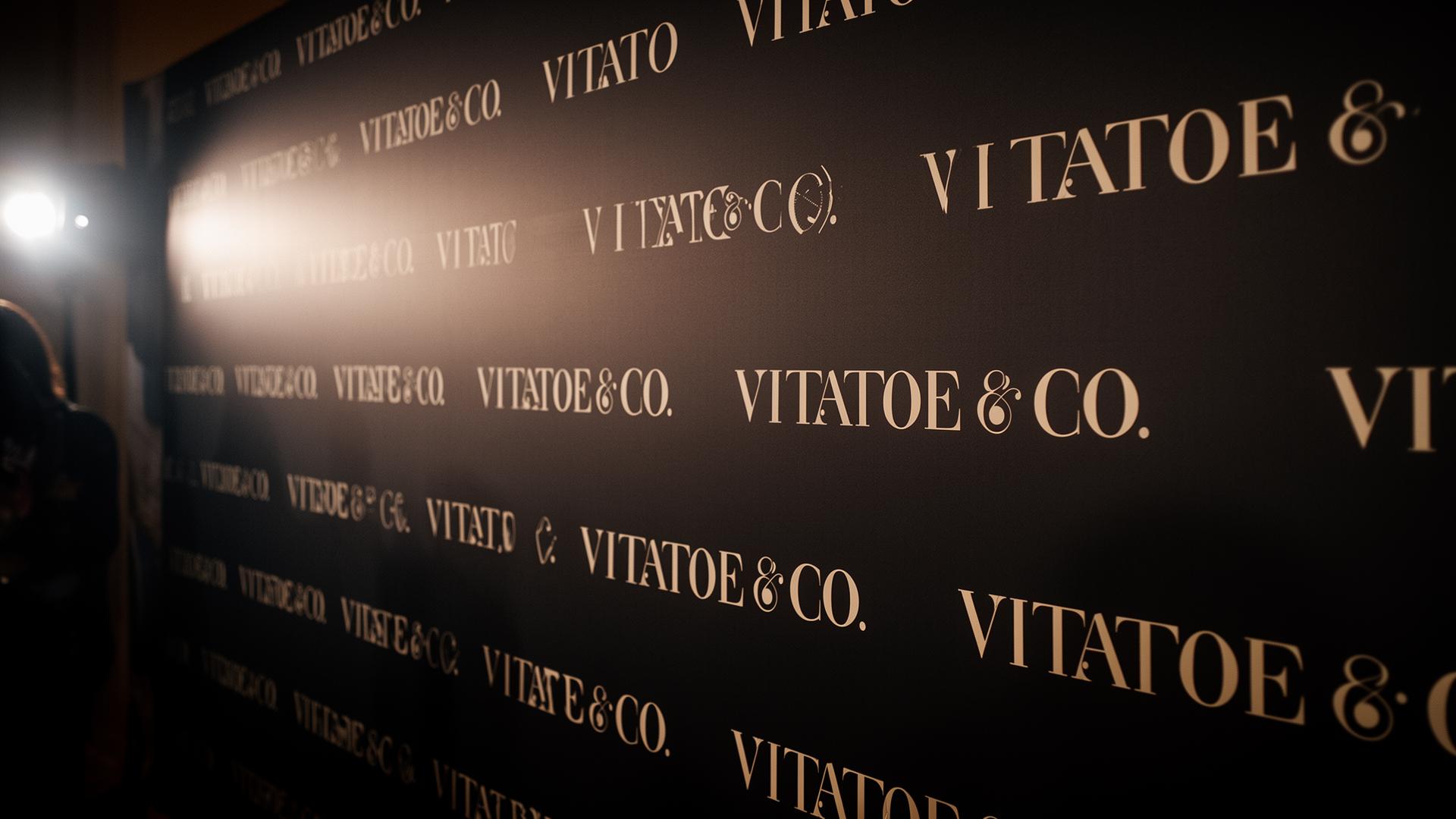 Vitatoe & Co. branded press wall at a media event